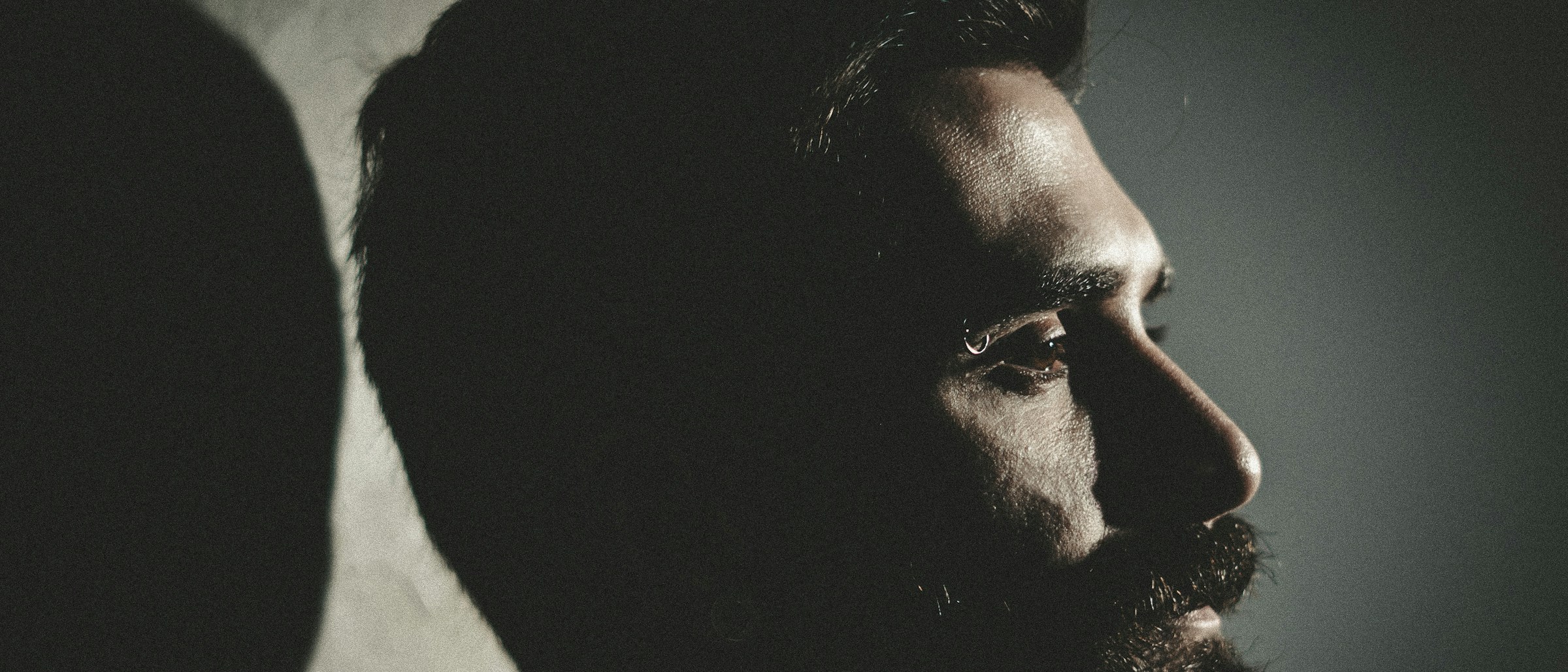 Close-up side profile of a man in low light